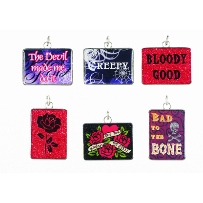 A collection of four rectangular charms with various Halloween-themed designs, including a black rose, bone, and text phrases such as 'THE DEVIL MADE ME DO IT' and 'BLOODY GOOD'. Each charm has a sparkly, glittery finish.